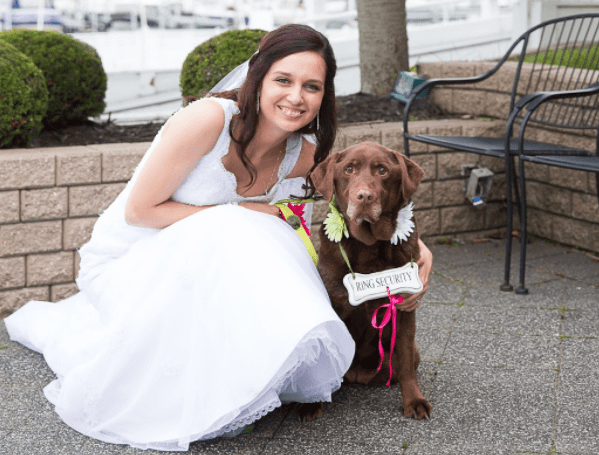 Sarah Burns in wedding dress with her dog